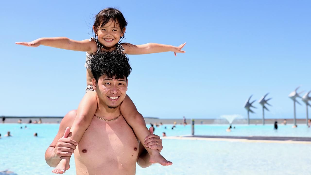 The weather in Cairns has started to warm up, with a long, hot summer forecast for Far North Queensland. Japanese tourists Tsuyoshi Oguri and his daughter Nayu Oguri, 3, cool off from the Cairns heat by taking a dip in the Cairns Esplanade lagoon. Picture: Brendan Radke