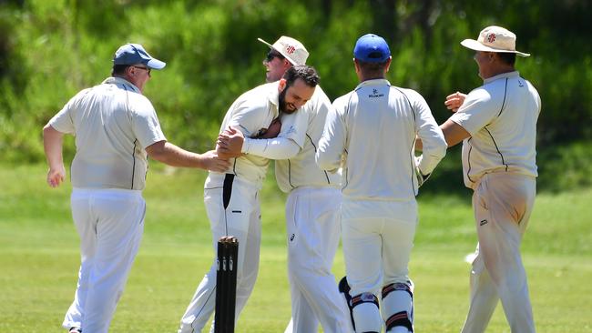 Indooroopilly bowler Scott Mainey gets hugs from his team mate after a wicket Sub districts cricket. Indooroopilly v Cleveland Thornlands. Saturday November 13, 2021. Picture, John Gass