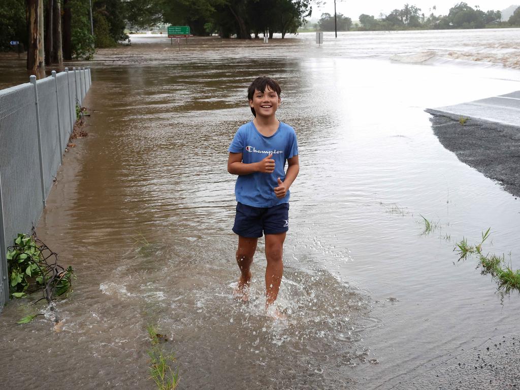 Jack Perris, 11, plays in the floodwaters of the Mossman River at the Foxton Bridge. Picture: Liam Kidston