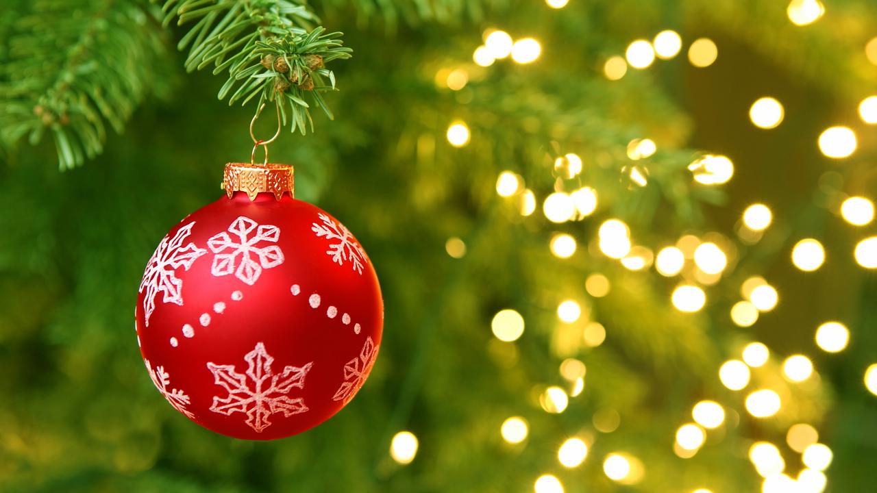 Red Christmas Ball Hanging on Christmas Tree with Blur Lights