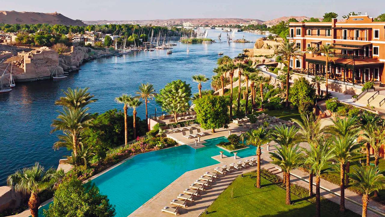 A contrast of modern hotel pool and ancient riverway where Sofitel Legend Old Cataract overlooks the Nile at Aswan.
