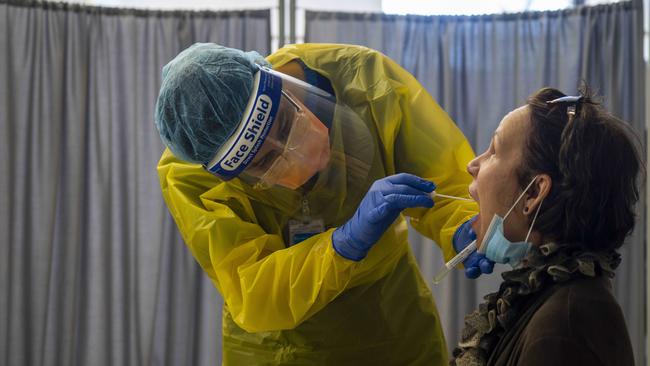 Nurse Cathy Morris in the Red Zone of the clinic performing a test on a patient. Image Matthew Vasilescu