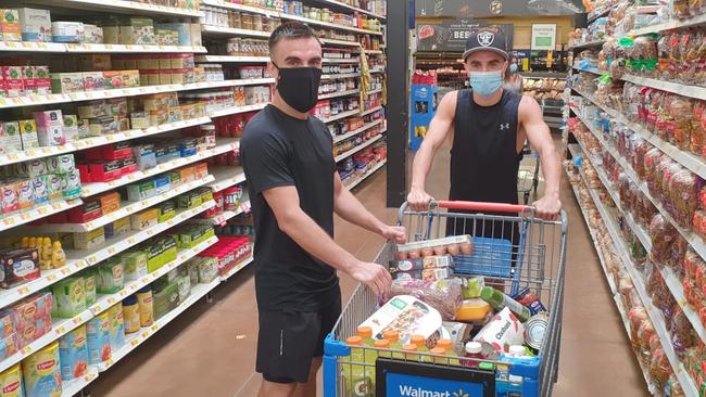 Andrew and Jason Moloney keep safe on a trip around the local grocery store.