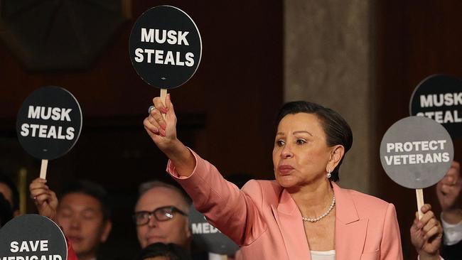 US Representative Nydia Velázquez holds a ‘Musk Steals’ protest sign with fellow Democrats as US President Donald Trump speaks. Picture: Win McNamee/Pool/AFP