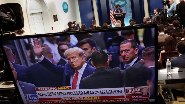 Donald Trump is beamed in during a White House briefing. Picture: Getty Images