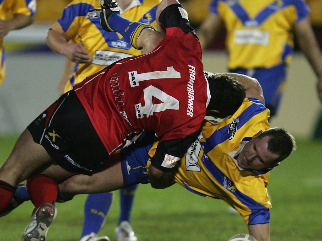 Baxter gets tackled during the 2006 Bartercard Cup grand final.