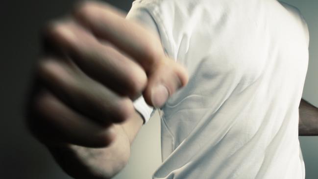 man in white t shirt and jeans throwing punch with motion blur -add text/graphics