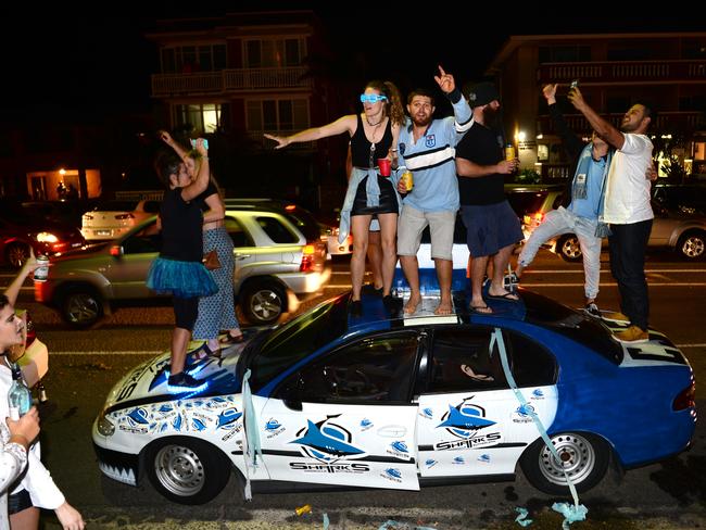 Up on the roof... Fans celebrate on top of car in the Shire. Picture: Jeremy Piper