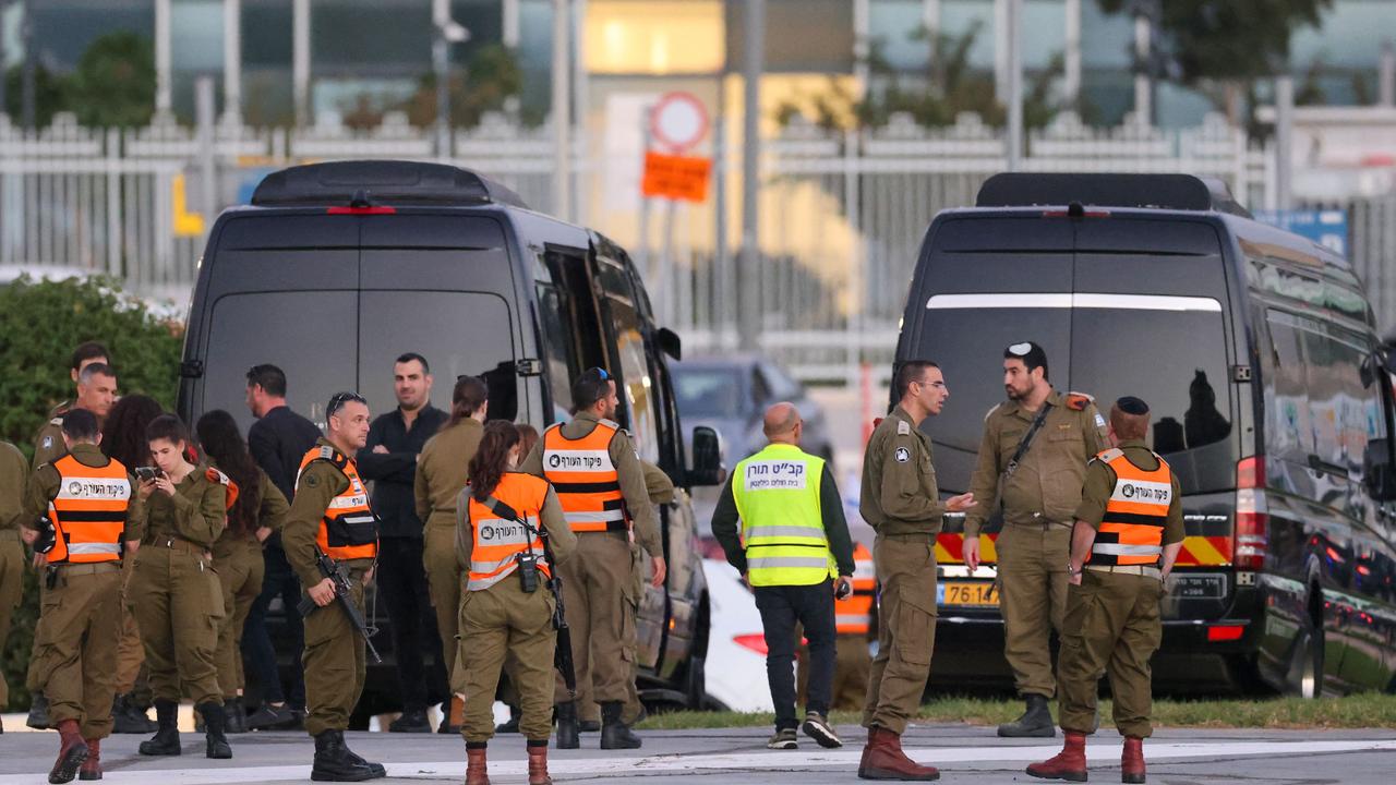 Israeli security forces stand next to buses waiting at the helipad of Tel Aviv's Schneider medical centre on November 24, 2023, amid preparations for the release of Israeli hostages. Picture: AFP