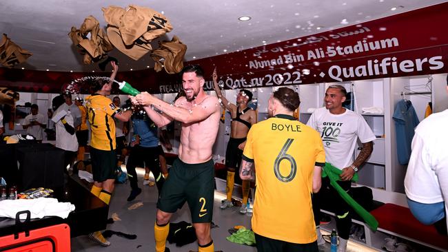 Milos Degenek (C) sprays water as Australia celebrates their World Cup-qualifying win over Peru. Picture: Getty