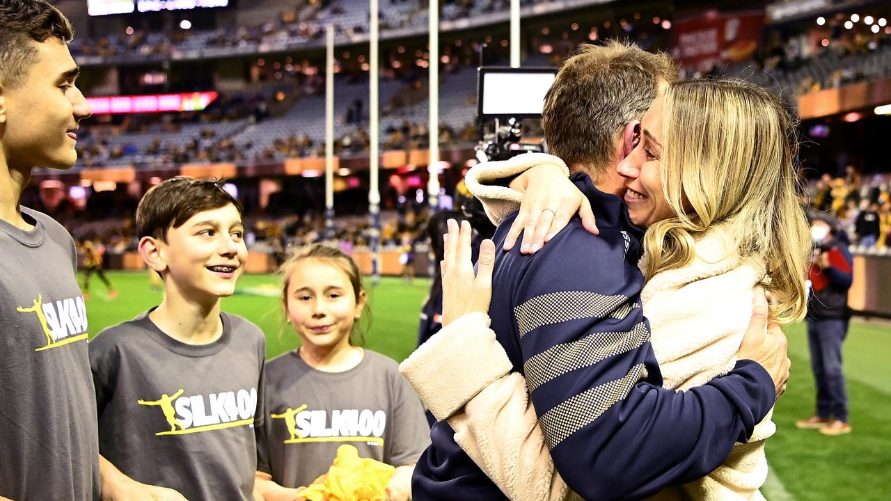 Hawks coach Alastair Clarkson hugs Amy Burgoyne as her children look on. Picture: Getty Images