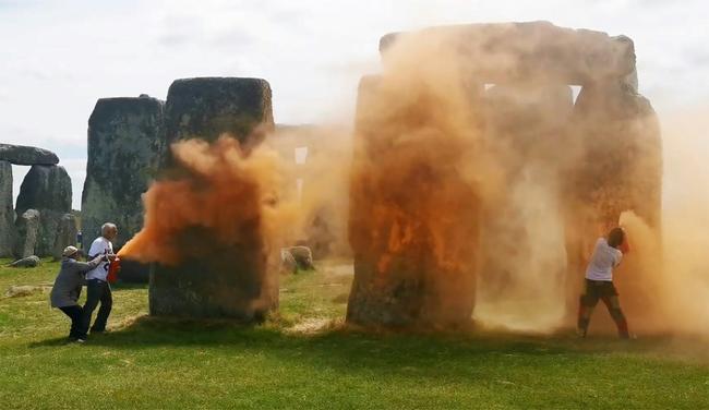 An image grab from a video released by Just Stop Oil shows activists spraying an orange substance at Stonehenge in Wiltshire, southwest England