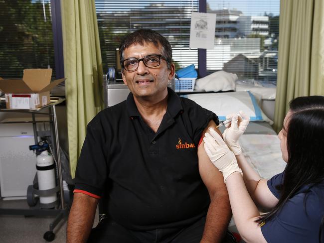 Nurse Christie Pham pictured gives Kaushik Depji the Covid-19 vaccine at the MyHealth Medical Centre. (Image/Josh Woning)