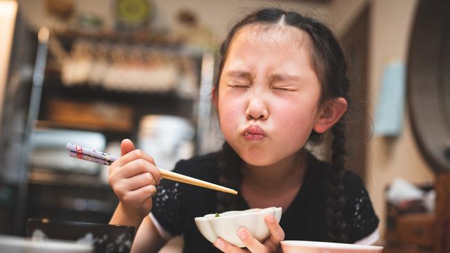 Girl eating Japanese food at home