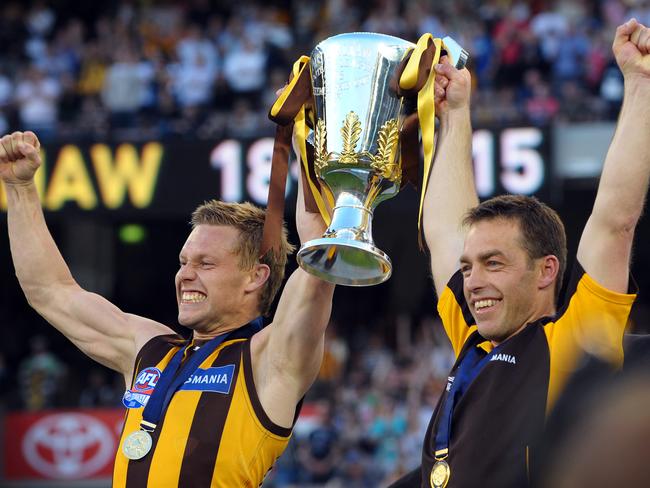 Sam Mitchell and Clarkson holding aloft the premiership cup in 2008 after beating Geelong. On Saturday the pair will face off as rival coaches for the first time.