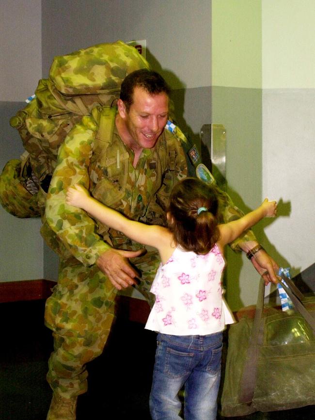 Australian Troops arriving at Townsville Airport from peace keeping in the Solomon Islands. Private Shane Hooper is welcomed home by daughter Billie, 5. Picture: Stewart Mclean