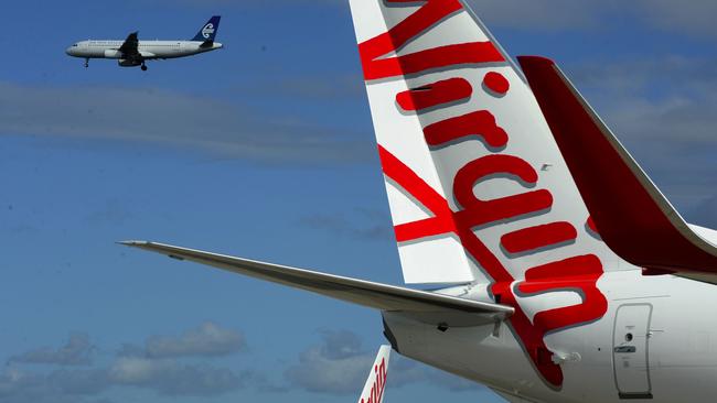 Two planes sporting the new branding for the Virgin Australia airline. PHOTO: AAP Image/Dean Lewins