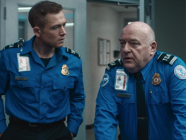 Taron Egerton as Ethan Kopek and Dean Norris as Phil Sarkowski in Carry-On.