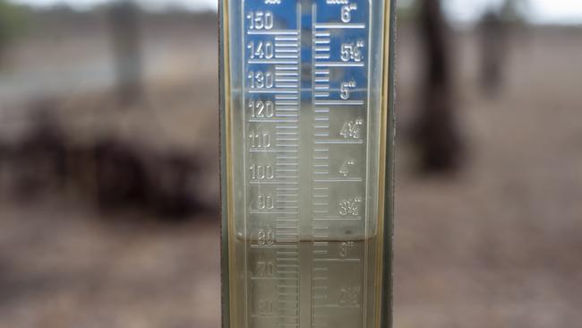 Rain Gauge with water reaching to the 80mm mark. Felton Farmer Paul Fuhlbohm enjoy the pool of water and the mud with his children Erin 5yr and Jack 2yr. at the family 800 acre property 162 km southwest of Brisbane. Property received 80mm of rain overnight from 5pm Friday afternoon. (contact: 0427935953) 18th January 2020. pic David Martinelli