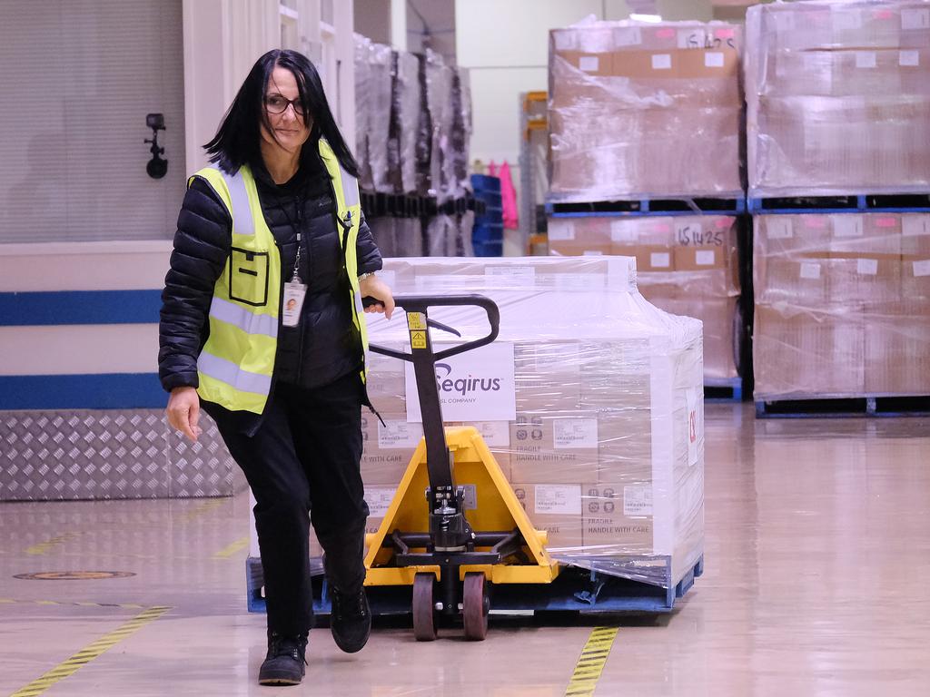 A workers at the CSL factory in Melbourne rolls out the first batch of locally-made AstraZeneca vaccine. Expects say we desperately need to ramp up production of the mRNA vaccines as well. Picture: Luis Ascui/Getty Images