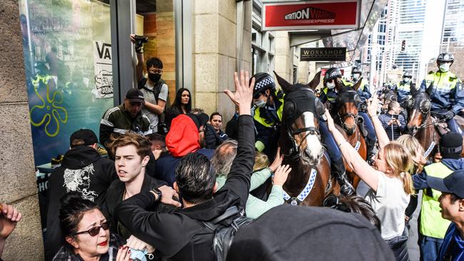 John Ruddick said the rally was the “happiest protest possible”. Police officers on horseback move in to help another officer. Picture: NCA NewsWire/Flavio Brancaleone