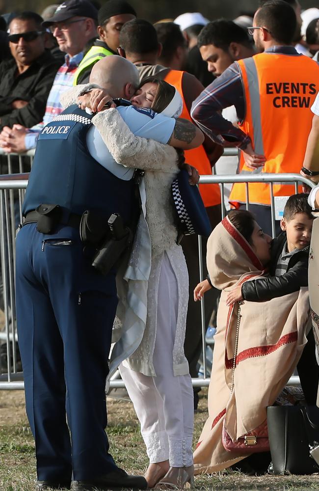 A Kiwi cop hugs a mourner at Friday’s service. Picture: Gary Ramage