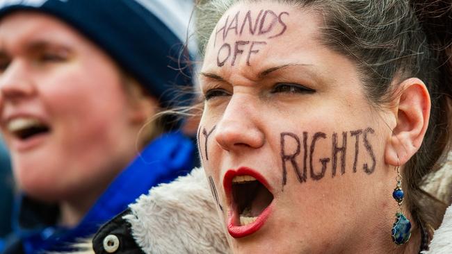 A woman with a message reading ‘hands off my rights’ participates in a protest against Mr Trump and his policies near the Massachusetts Statehouse. Picture: Joseph Prezioso/AFP