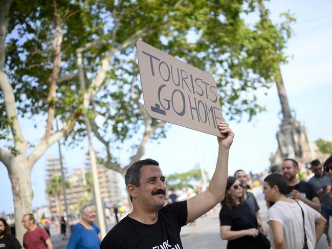 Demonstrators displayed banners reading ‘tourists go home’. Picture: AFP