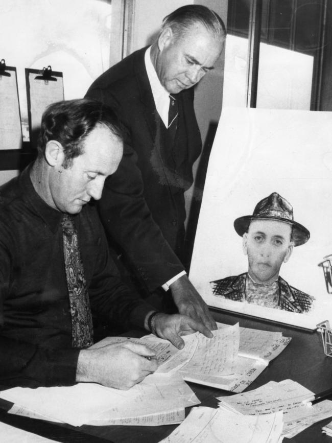 CIB Chief Superintendent Noel Lenton, right, and Det Sgt Norm Davey, left, working on the disappearance case at police headquarters in September 1973. In the background is a composite photo of the man seen with the missing children.