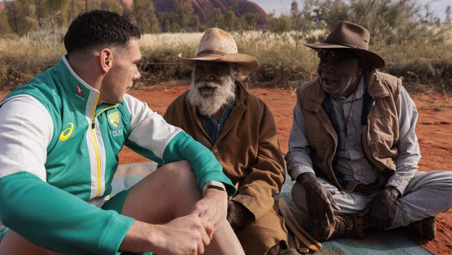 Boland chats to elders Rolly Mintima and Reggie Uluru during his time in the heart of Australia. Picture: Brook Mitchell/Getty Images