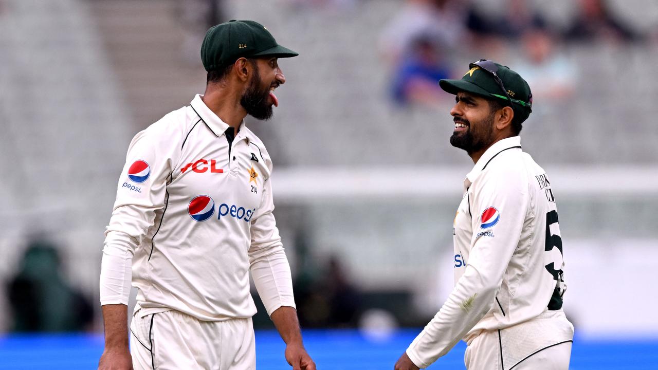 Pakistan captain Shan Masood reacts with teammate Barbar Azam after dropping a difficult catch on the first day of the second cricket Test match between Australia and Pakistan.