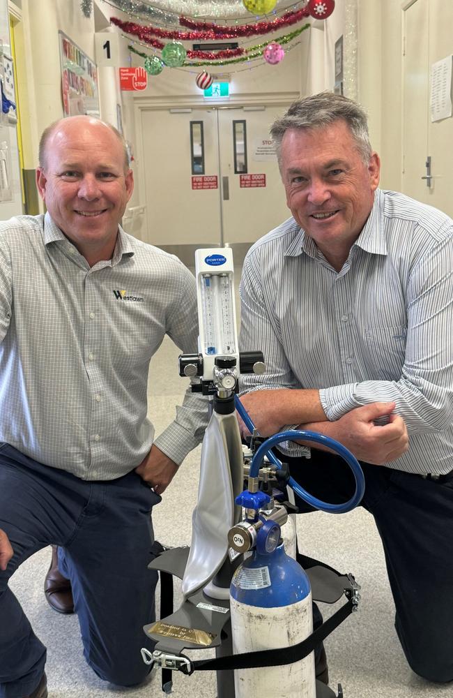 Westlawn Finance Business Development Manager Damien Rouse and, left, with Executive Director Geoff Scofield examining the new equipment.