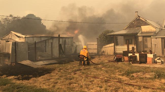 Tim Barry from the Ullina CFA protecting a home in Raglan on Thursday. Picture: Russell Keith