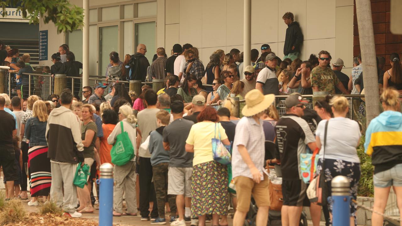 People queue to buy non-refrigerated food from Batemans Bay Coles. Picture: John Grainger