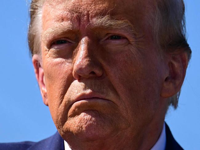 TOPSHOT - Former US President and Republican presidential candidate Donald Trump speaks to the media in Swannanoa, North Carolina, on October 21, 2024, after observing cleanup efforts in the aftermath of Hurricane Helene, which devastated the region. (Photo by Jim WATSON / AFP)