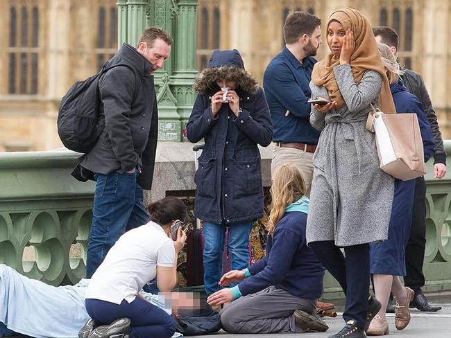 A Muslim woman seen at Westminster attack was accused of being insensitive – but not was all as it seemed. Picture: Jamie Lorriman