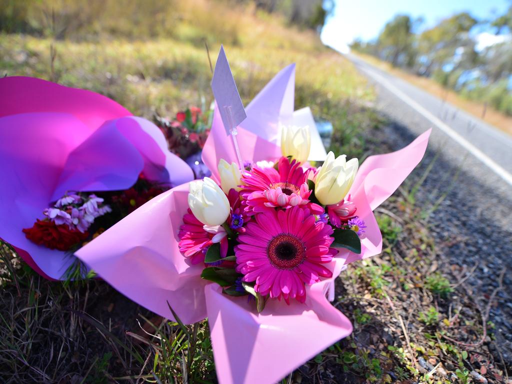 Flowers on the roadside mark the scene of a fatal crash.