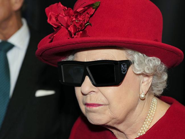 SHEFFIELD, ENGLAND - NOVEMBER 18: Queen Elizabeth II  and Prince Philip, Duke of Edinburgh wear 3 D glasses to watch a display and pilot a JCB digger, during a visit to the University of Sheffield Advanced Manufacturing Research centre, on November 18, 2010 in Sheffield, England. (Photo by John Giles - WPA Pool/Getty Images)