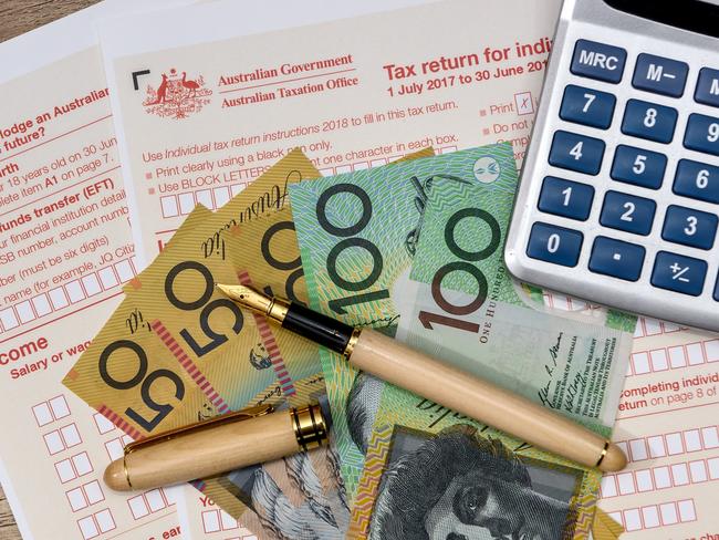 Australian dollars with calculator and tax form, tax time generic money, forms, taxation