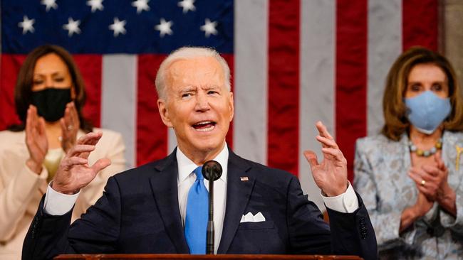 Joe Biden addresses a joint session of congress on Thursday as Kamala Harris, left, and Nancy Pelosi applaud at the US Capitol in Washington. Picture: AFP