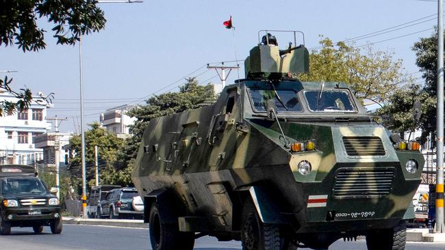 Military vehicles are seen along a street in Mandalay on February 2, 2021, as Myanmar's generals appeared in firm control a day after a surgical coup that saw democracy heroine Suu Kyi detained. (Photo by STR / AFP)