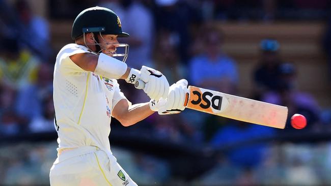 Australia's batsman David Warner pulls the ball away from the England bowling on the first day of the second Ashes cricket Test match in Adelaide on December 16, 2021. (Photo by William WEST / AFP) / — IMAGE RESTRICTED TO EDITORIAL USE – STRICTLY NO COMMERCIAL USE —