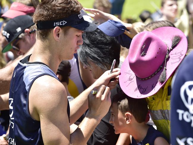 Cowboy's Kalyn Ponga signs Keisha Peachey’s hat during the open training day. Picture: Wesley Monts