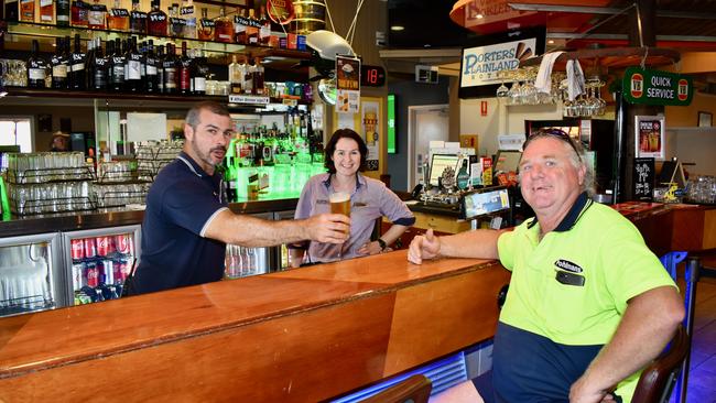 Chris Donovan (right) enjoys a cold beer on the house after he helped save Mel and Michael's Porters pub early in the morning. Photo: Hugh Suffell.