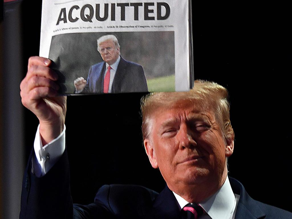 US President Donald Trump holds up USA Today front page article with a headline ‘Acquitted’ in Washington, D.C. Picture: Nicholas Kamm/AFP