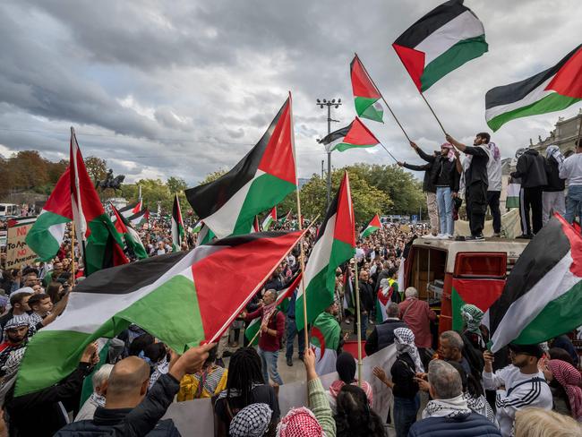 Protesters wave Palestinian flags during a rally in support of Palestinians in Geneva. Picture: AFP