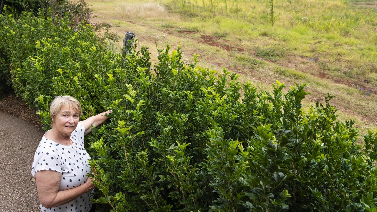 Frew St resident Kelly Seccombe demonstrates the proximity of the development boundary to her five acre property as Darling Heights residents and concerned citizens protest a subdivision development in Frew St, Monday, January 23, 2023. Picture: Kevin Farmer