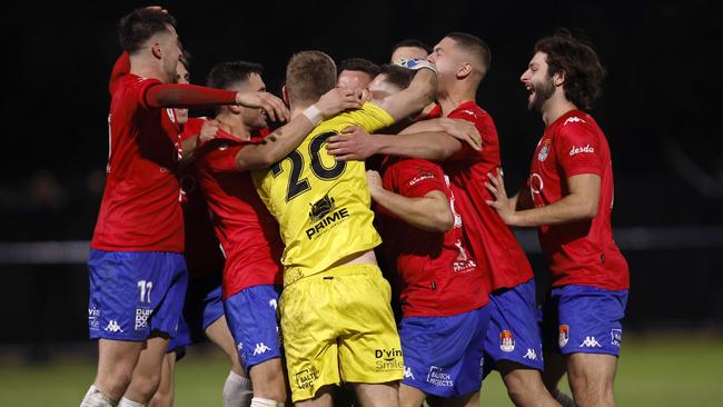 FC Melbourne players celebrate winning on penalties.