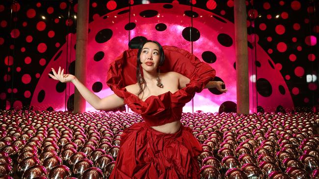 Musician Elle Shimada in the Narcissus Garden of chrome spheres. Picture: David Caird