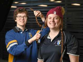 CRUCIAL CUTS: Bremer State High School student and brain cancer survivor Kieran McLeod prepares to cut off the hair of teacher Elizabeth Ricketts to raise money for Beanies for the Cure Brain Cancer Foundation. Picture: Rob Williams